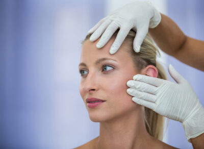 doctor-examining-female-patients-face-from-cosmetic-treatment (1)